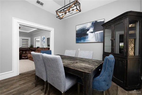 a dining room with furniture and wooden floor