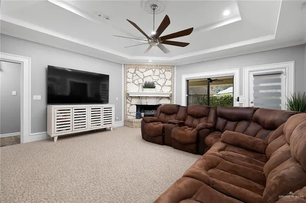 a living room with furniture a window and a flat screen tv