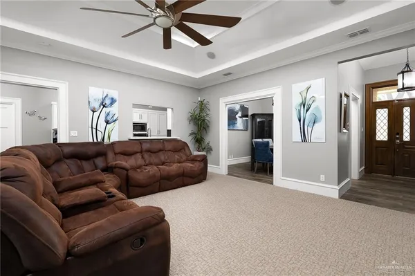a living room with furniture ceiling fan and a rug