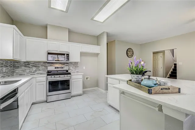 a kitchen with a sink stove and cabinets