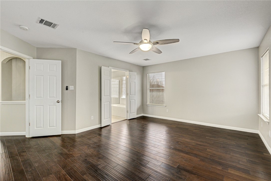 3504 Texas Topaz Drive Austin, TX 78728 - Photo 17 of 29 a view of an empty room with wooden floor and a window