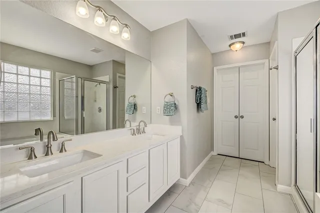 a bathroom with a double vanity sink mirror and double