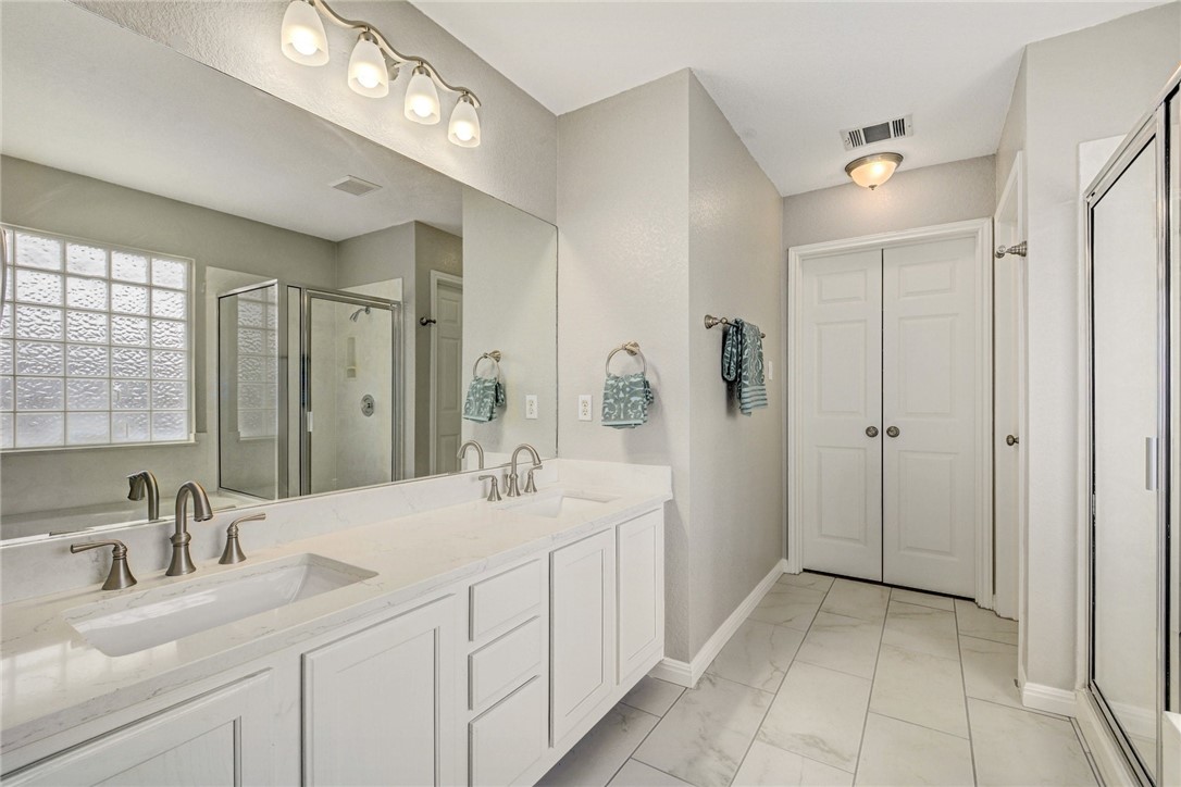 3504 Texas Topaz Drive Austin, TX 78728 - Photo 18 of 29 a bathroom with a double vanity sink mirror and double