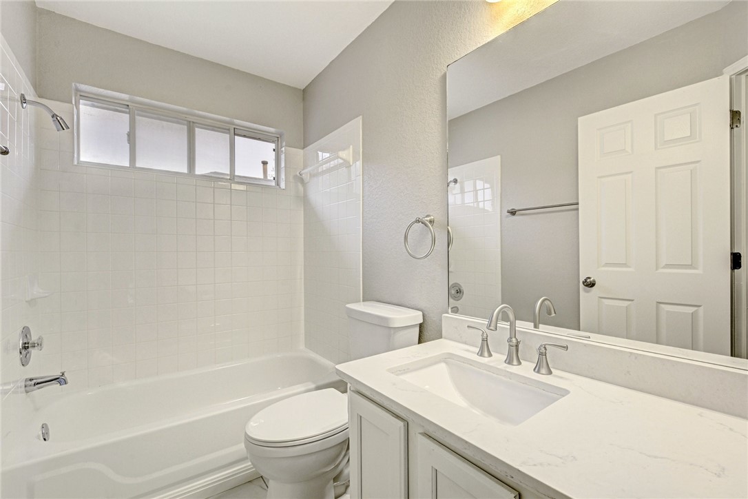 3504 Texas Topaz Drive Austin, TX 78728 - Photo 22 of 29 a bathroom with a sink a toilet and a large mirror