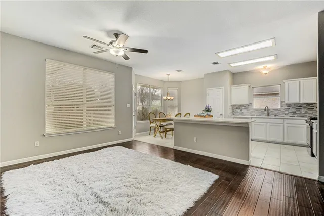 a kitchen with stainless steel appliances granite countertop a stove a sink dishwasher and a oven with white cabinets