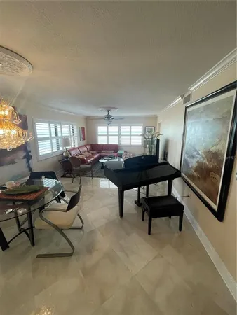 a living room with furniture a window and a flat screen tv