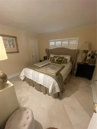 a bed sitting in a bedroom and table