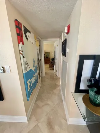 a view of a hallway to rooms and stairs