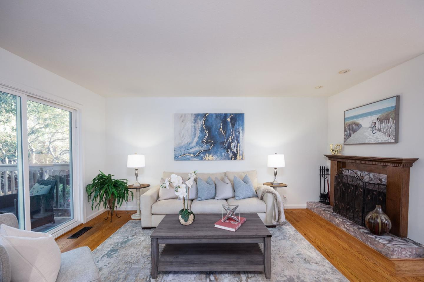 1204 Rainier Avenue Pacifica, CA 94044 - Photo 13 of 38 a living room with furniture a fireplace and a floor to ceiling window