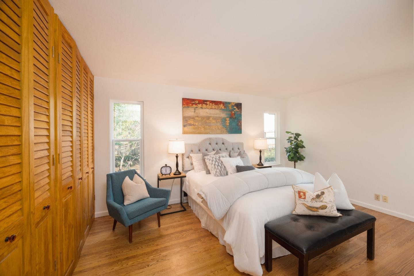 1204 Rainier Avenue Pacifica, CA 94044 - Photo 17 of 38 a bedroom with a bed and wooden floor