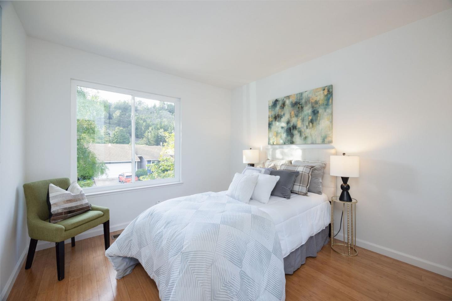 1204 Rainier Avenue Pacifica, CA 94044 - Photo 19 of 38 a bedroom with a bed and a chair