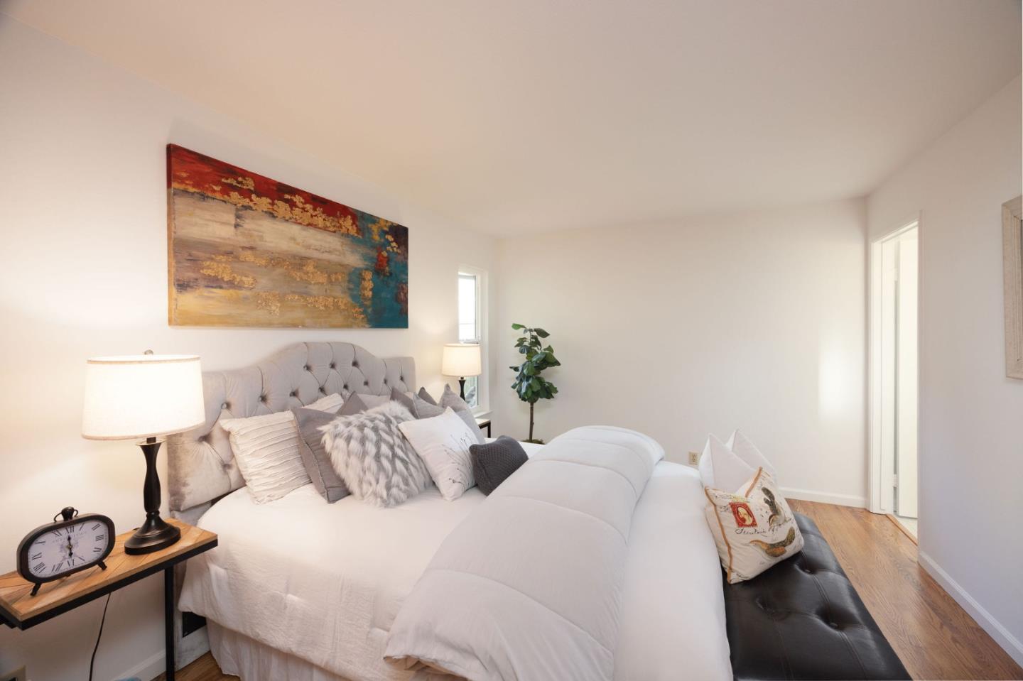 1204 Rainier Avenue Pacifica, CA 94044 - Photo 27 of 38 a bedroom with a bed and a lamp