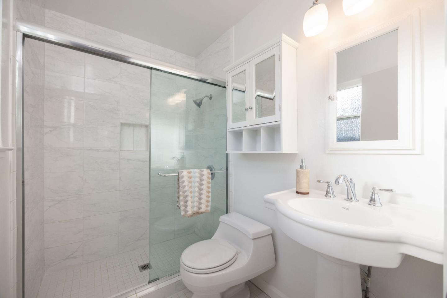 1204 Rainier Avenue Pacifica, CA 94044 - Photo 28 of 38 a bathroom with a sink toilet and shower