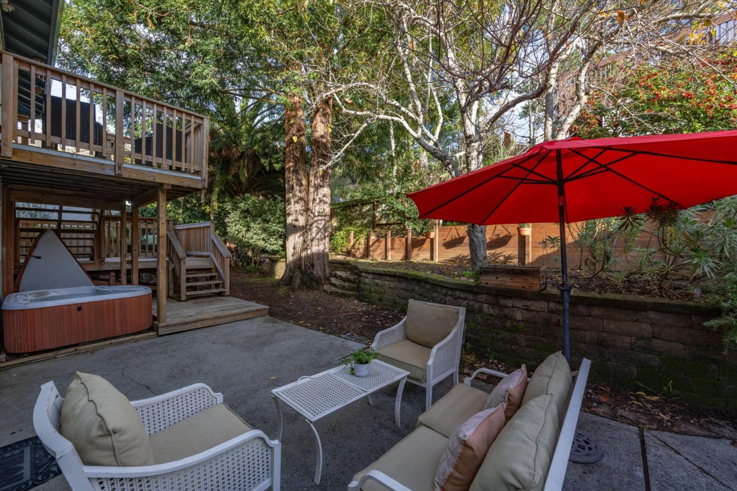 1204 Rainier Avenue Pacifica, CA 94044 - Photo 36 of 38 a patio with a table and chairs under an umbrella
