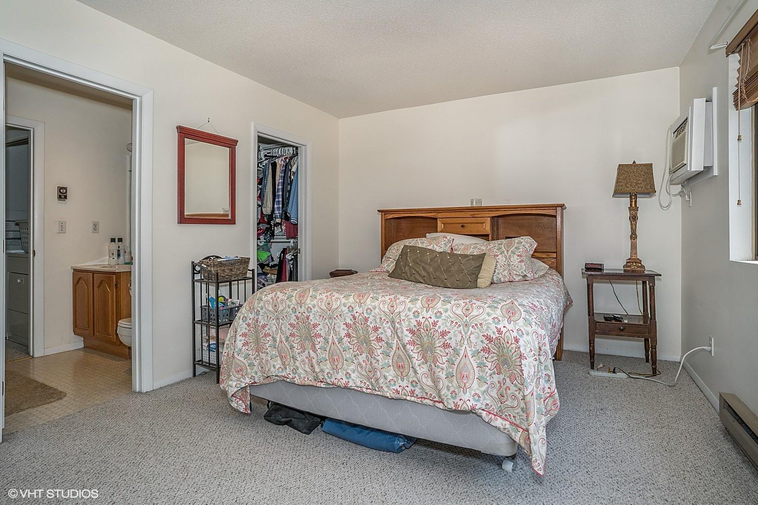 67 Round House Road Bourne, MA 02532 - Photo 9 of 15 a bed sitting in a bedroom next to a bathroom