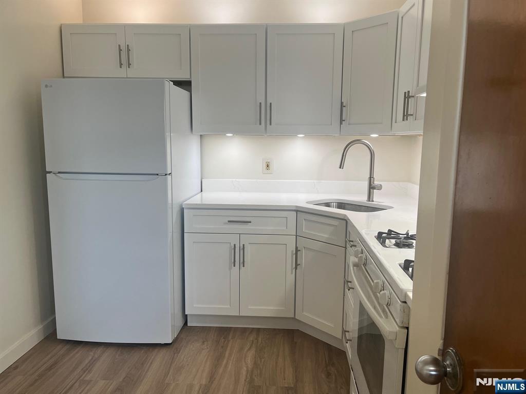 635 B Ridge Road, Unit B Lyndhurst, NJ 07071 - Photo 11 of 16 a kitchen with a sink a refrigerator and cabinets