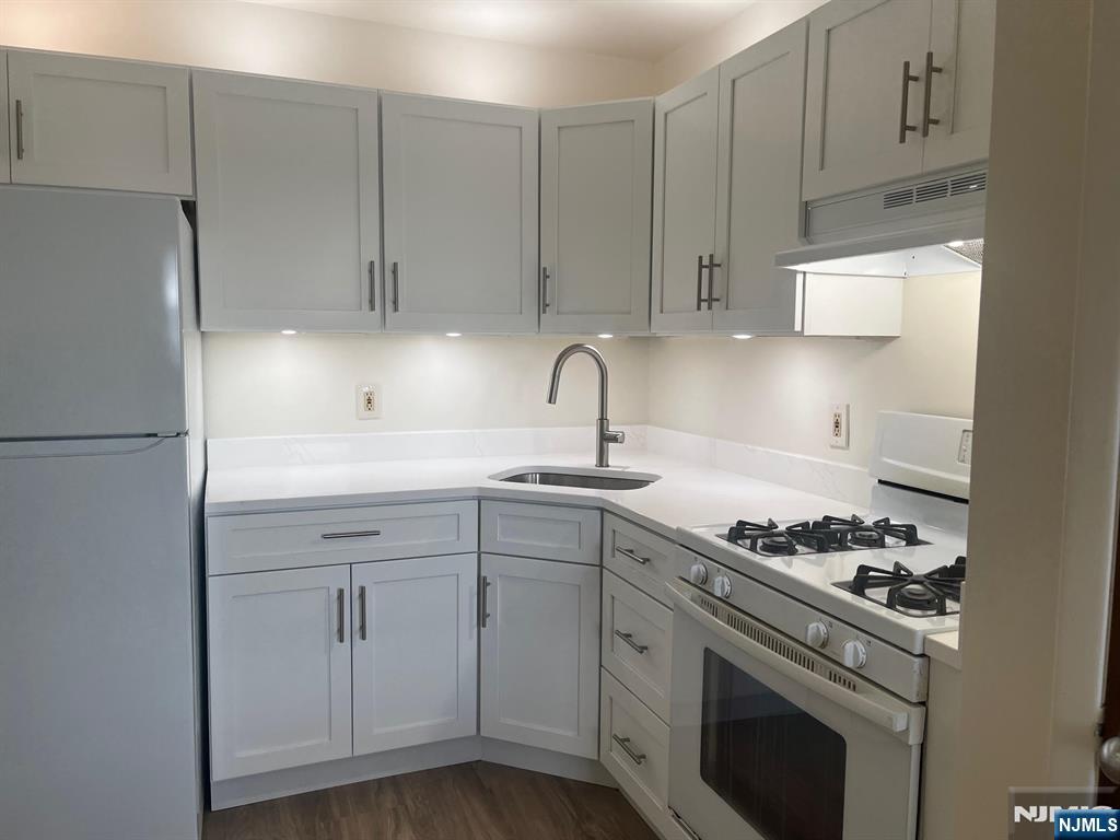 635 B Ridge Road, Unit B Lyndhurst, NJ 07071 - Photo 12 of 16 a kitchen with cabinets appliances and a sink