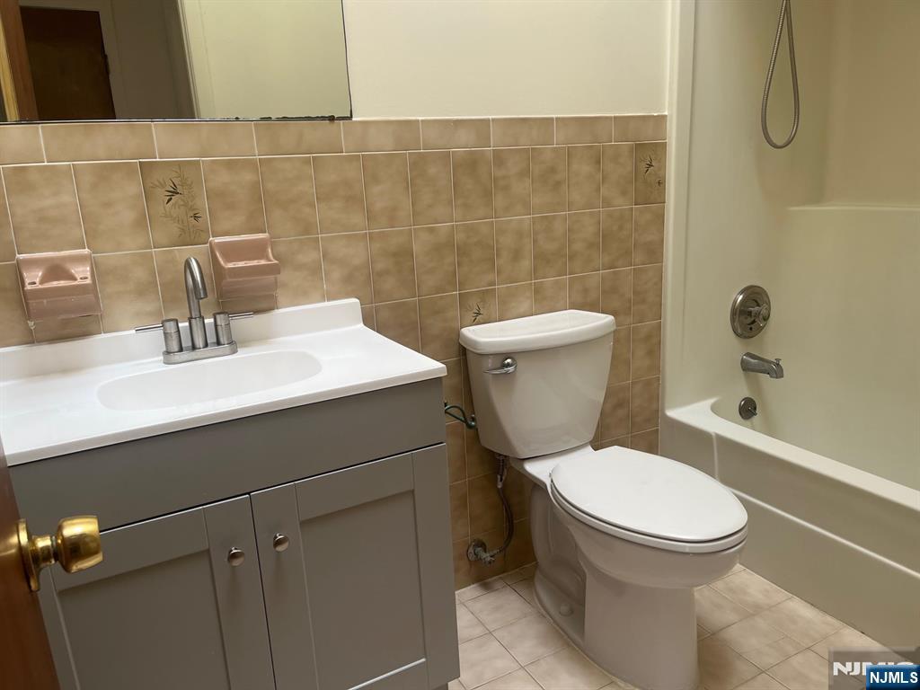 635 B Ridge Road, Unit B Lyndhurst, NJ 07071 - Photo 15 of 16 a bathroom with a sink a toilet and a mirror
