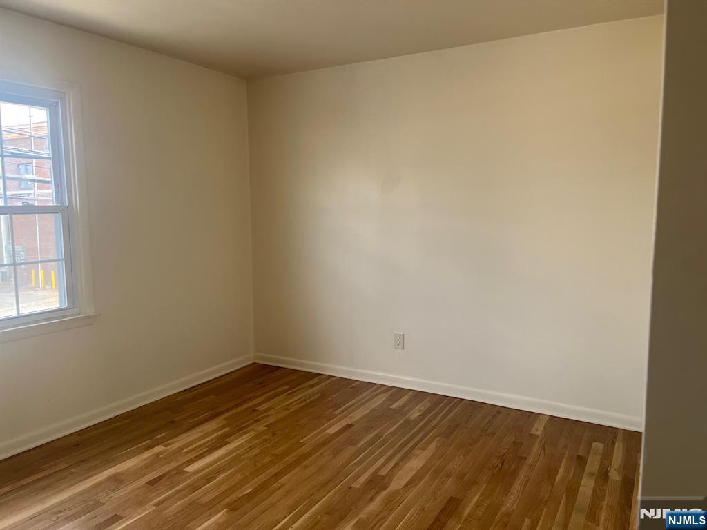 635 B Ridge Road, Unit B Lyndhurst, NJ 07071 - Photo 5 of 16 an empty room with wooden floor and windows