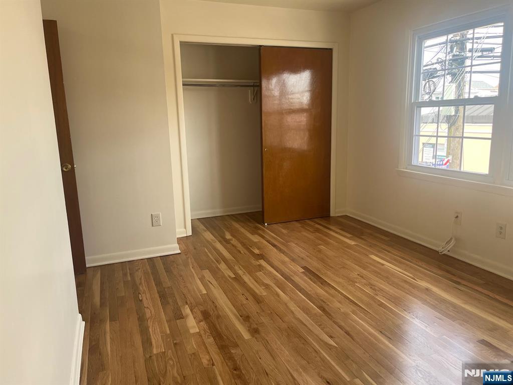 635 B Ridge Road, Unit B Lyndhurst, NJ 07071 - Photo 9 of 16 an empty room with wooden floor and windows
