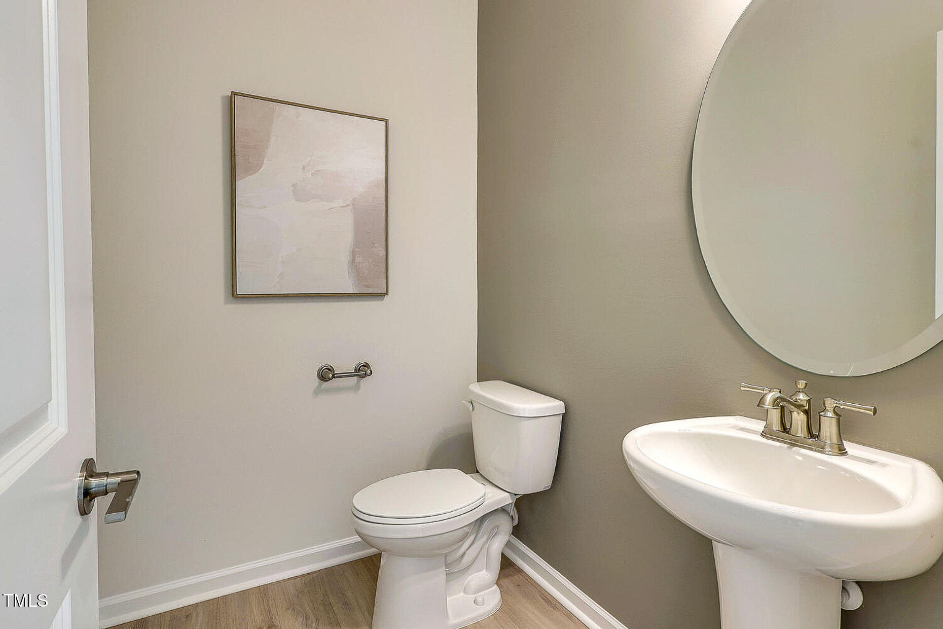 1416 Chrysalis Place Apex, NC 27502 - Photo 7 of 10 a bathroom with a toilet sink and mirror