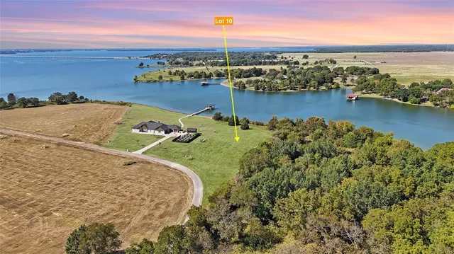 an aerial view of a house with a lake view