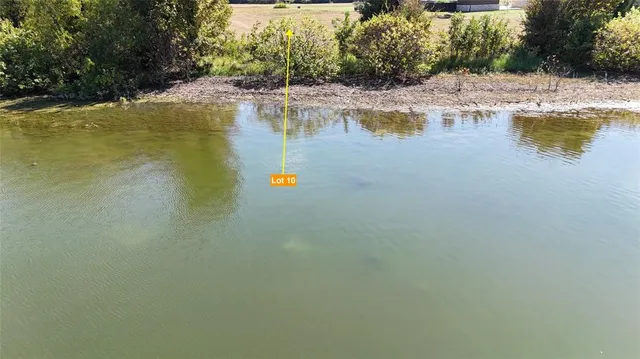 a view of a lake with beach and outdoor space
