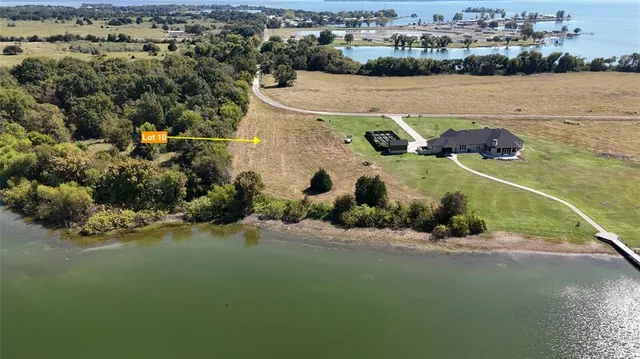 an aerial view of a houses with a lake