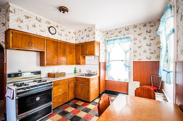 257 Market Street Boston, MA 02135 - Photo 13 of 16 a kitchen with stainless steel appliances a stove a sink and a refrigerator with wooden floor