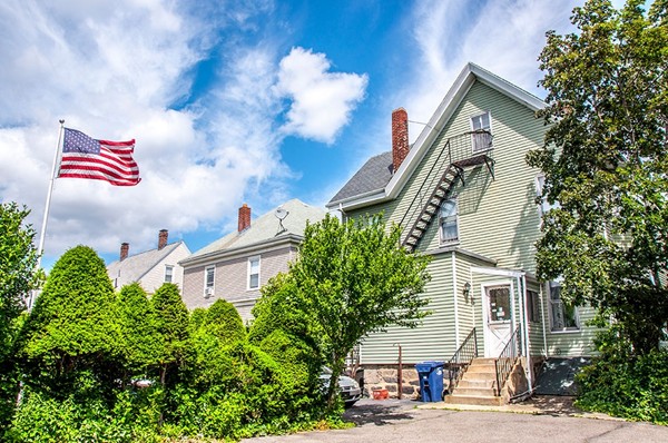 257 Market Street Boston, MA 02135 - Photo 3 of 16 a front view of a house with a tree