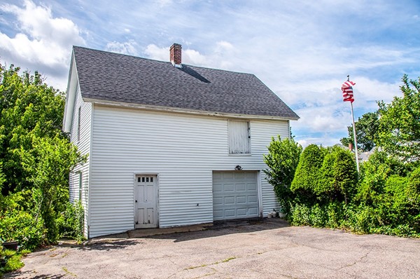 257 Market Street Boston, MA 02135 - Photo 5 of 16 a front view of a house with a garden