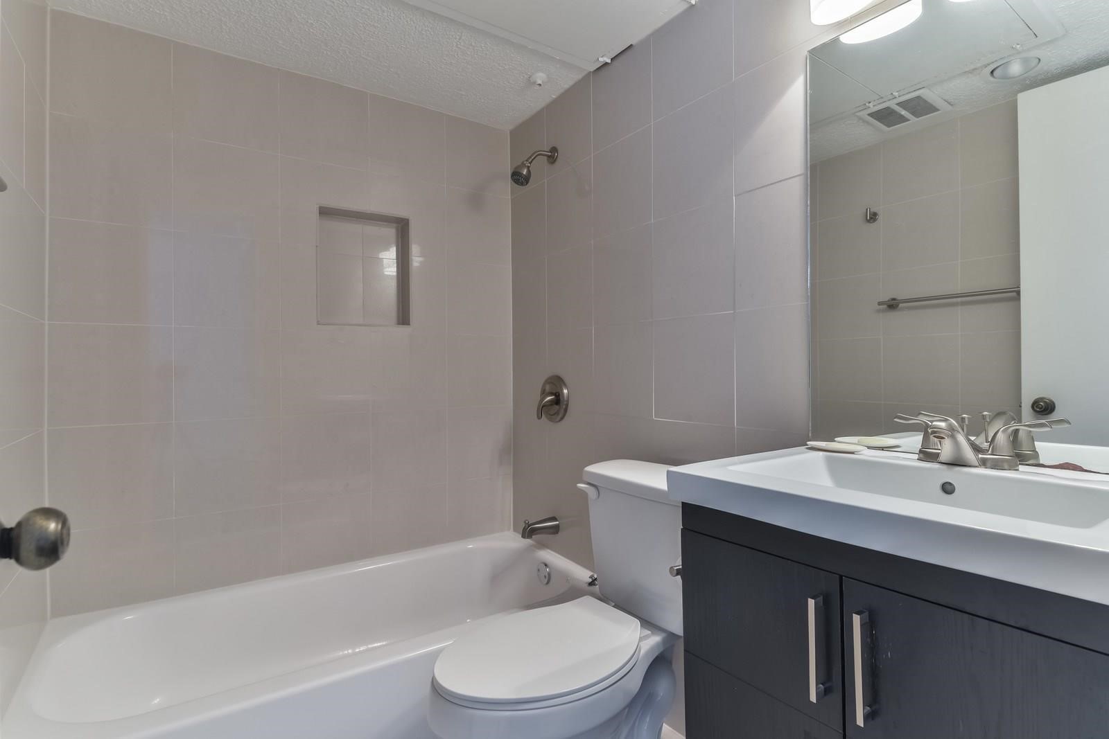 6402 Del Monte Drive, Unit 45 Houston, TX 77057 - Photo 13 of 20 a bathroom with a sink a toilet and shower