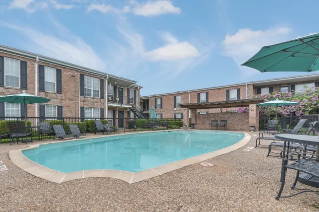 a view of a house with a swimming pool and sitting area