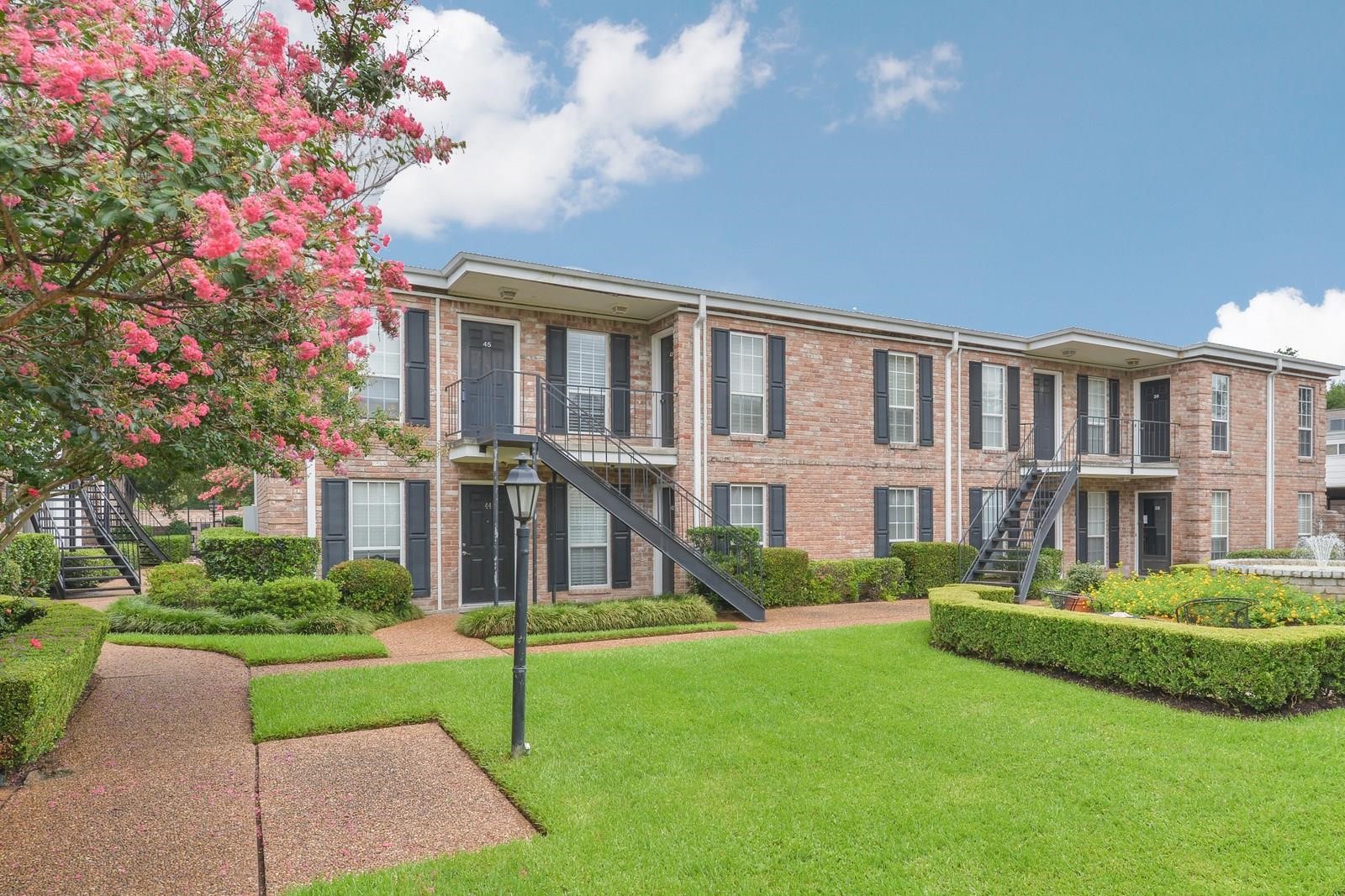 6402 Del Monte Drive, Unit 45 Houston, TX 77057 - Photo 17 of 20 a front view of building with yard and green space