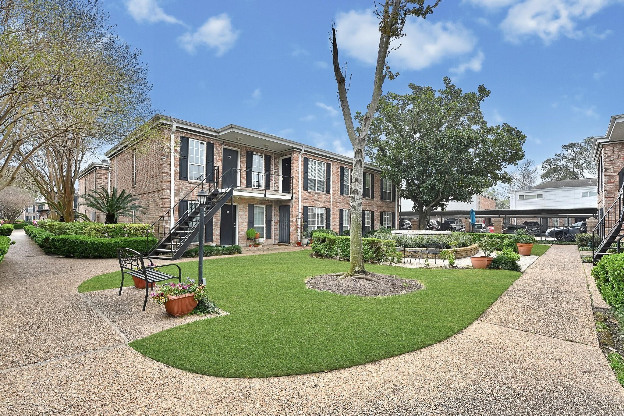 6402 Del Monte Drive, Unit 45 Houston, TX 77057 - Photo 19 of 20 a front view of a house with a yard table and chairs
