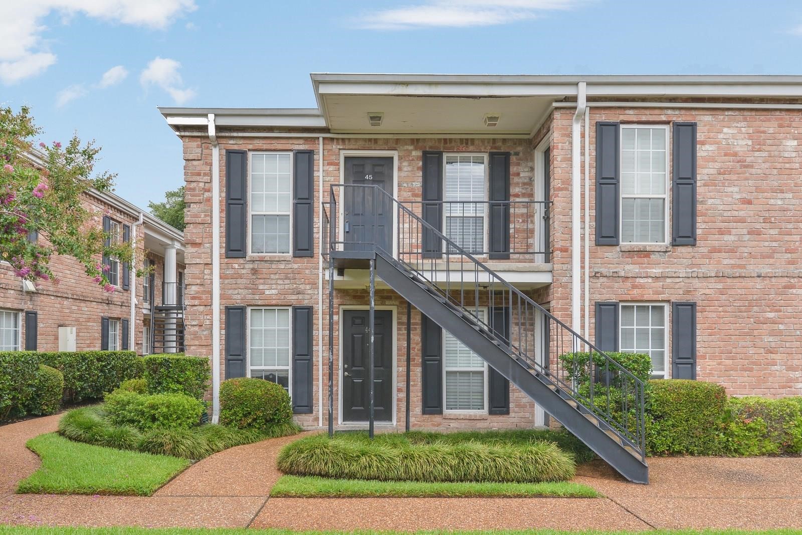 6402 Del Monte Drive, Unit 45 Houston, TX 77057 - Photo 2 of 20 front view of brick house with a yard