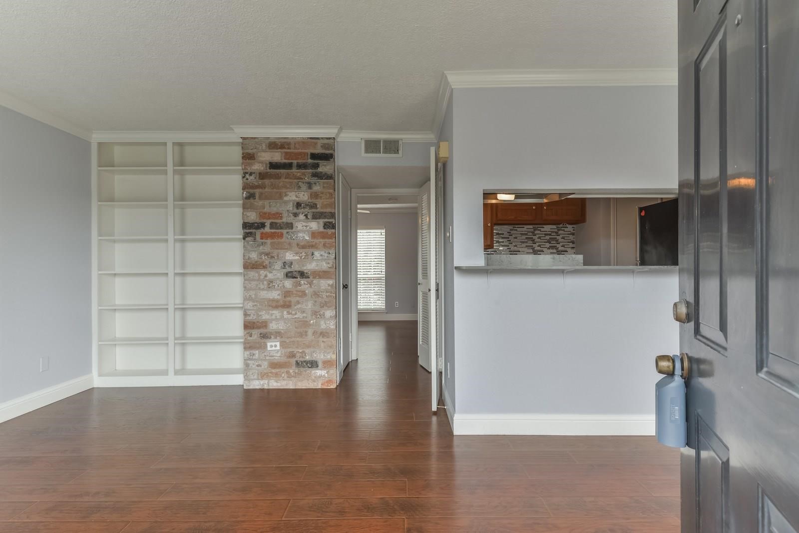 6402 Del Monte Drive, Unit 45 Houston, TX 77057 - Photo 4 of 20 a view of a hallway with wooden floor and a cabinet