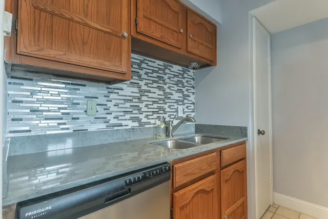 a kitchen with granite countertop a sink and cabinets