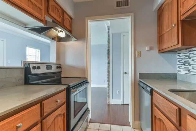 a kitchen with stainless steel appliances granite countertop a sink and a stove