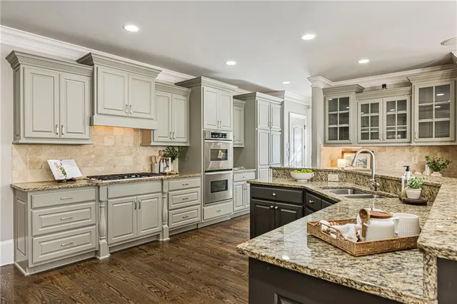 a kitchen with stainless steel appliances granite countertop a stove and a sink