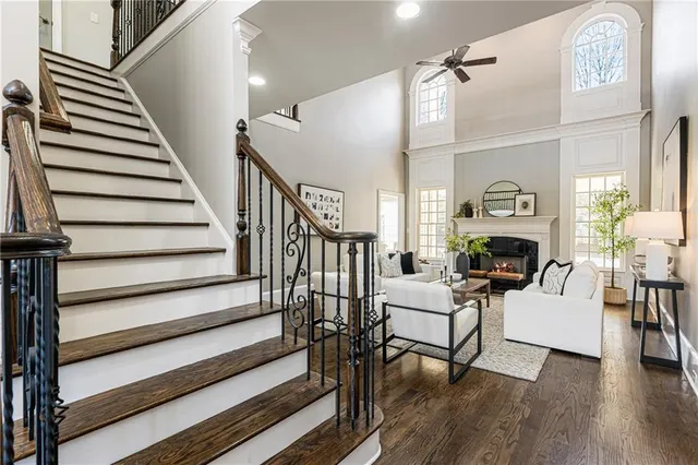 a spacious en suite bathroom with a granite countertop sink and a large mirror