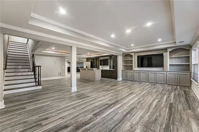 a view of swimming pool with lawn chairs and plants