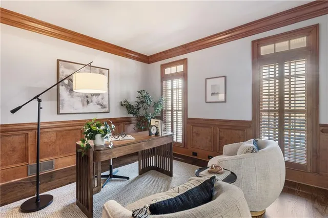 a living room with furniture a fireplace and a large window