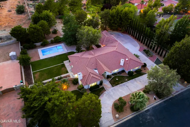 a large white kitchen with stainless steel appliances