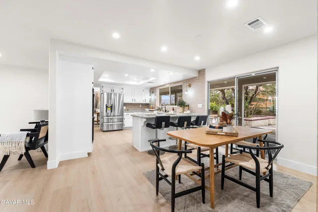 a kitchen with stainless steel appliances a white sink and cabinets