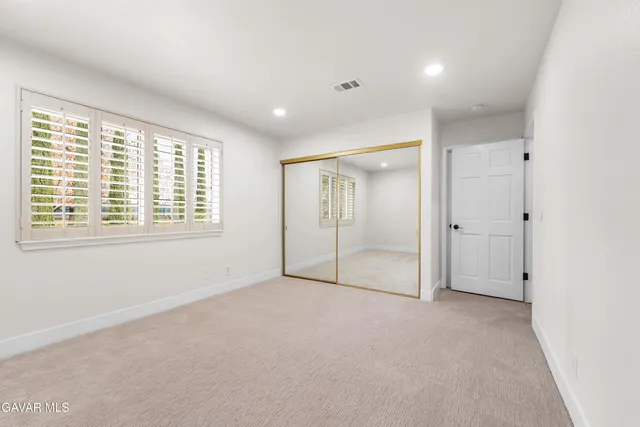a bathroom with a granite countertop sink and a large mirror