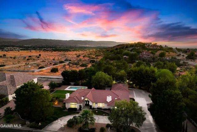 an aerial view of a house with a yard and a fountain