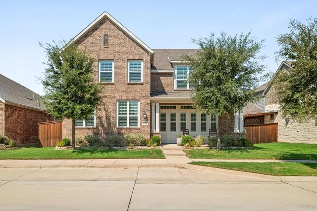 a front view of a house with a yard and a garage