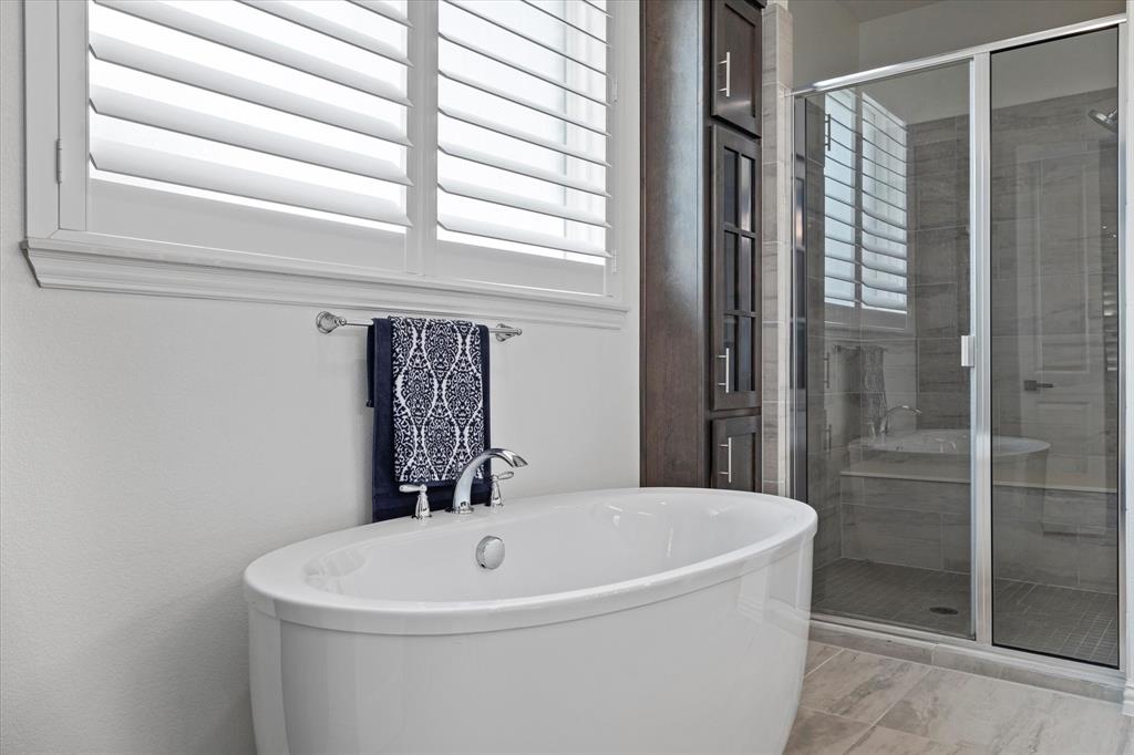 1561 William Way Dallas, TX 75234 - Photo 13 of 38 a white bath tub sitting next to a shower