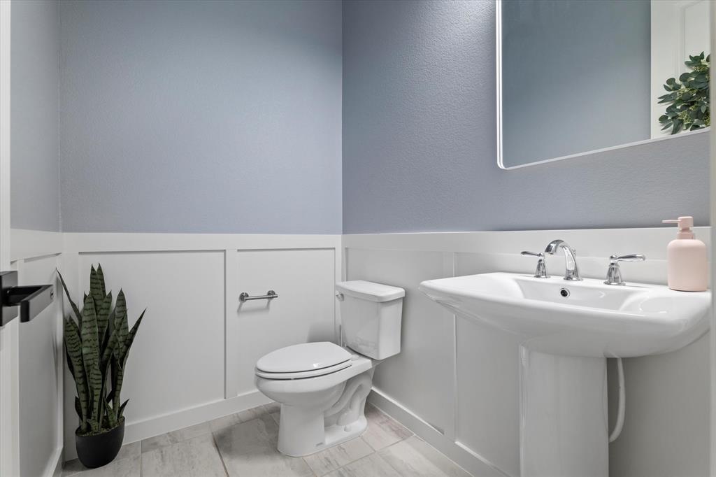 1561 William Way Dallas, TX 75234 - Photo 15 of 38 a white toilet sitting next to a bathroom sink